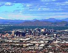 A photo showing the skyline of Phoenix, looking north. It shows the various buildings of the downtown area, as well as Sunnyslope Mountain in the background