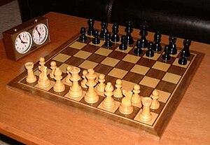 Chess game and play clock with the pieces in t...