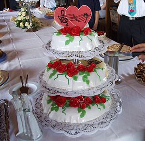 Wedding cake with hearts and roses on the buff...