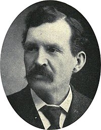 oval portrait photograph of a man with a large mustache