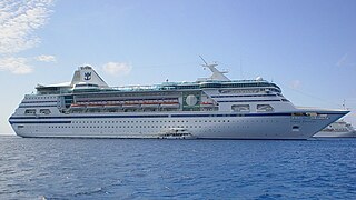 MS Nordic Empress, featuring her original Royal Caribbean livery, anchored off the Cayman Islands in late March 2004