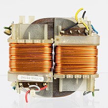 An O-core transformer consisting of two coils of copper wire wrapped around a magnetic core Philips N4422 - power supply transformer-2098.jpg