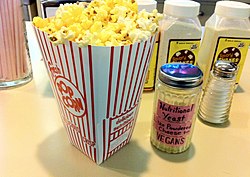 Some theatres offer visitors nutritional yeast for popcorn seasoning. Popcorn with Nutritional yeast.jpg