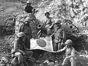 U.S. Marines with a captured Japanese flag on Iwo Jima