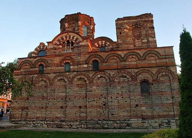 A Byzantine-style church decorated with blind arcades and missing entrances on this side