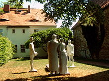 Sculpture Das Rockener Bacchanal by Klaus Friedrich Messerschmidt (2000), near Nietzsche's grave at Rocken in Germany. Geburtshaus Friedrich Nietzsches mit Skulpturengruppe Rocken.jpg