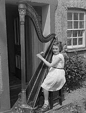 A girl harpist wearing twin-strap T-bar sandals in Wales, 1960.