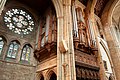 The double-fronted gothic organ case, designed by the architect's son, and north transept (rose) window