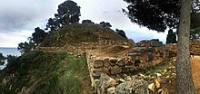 stone walls on a rocky promontory overlooking the sea