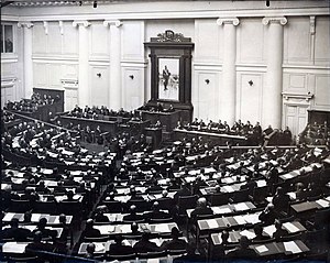 Prime Minister Vladimir Kokovtsov reading a government report in the State Duma. 5 December 1912 Count Kokovtsov's speech in Duma.jpeg