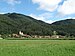 St. Radegund bei Ruden, Kärnten, von Südosten, im Hintergrund Wiesenbauerkogel und Langer Berg