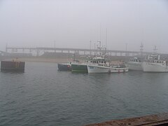 Fishing boats moored at the quayside, ore port facilities