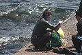 After emerging from the sea, haenyeo selling her gathered seafood to people on the coast of Jeju.