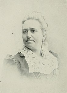 B&W portrait photo of a woman with her hair in an up-do.