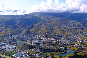 View of a city in front of a mountain.