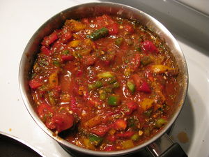 A sauce containing tomato puree, diced tomatoe...