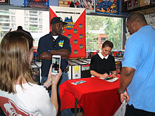 As actress Alyssa Milano autographs a copy of her graphic novel during an appearance at Midtown Comics in Manhattan, her assistant (left foreground) streams video of the event on Periscope. 9.12.15AlyssaMilanoByLuigiNovi68.jpg