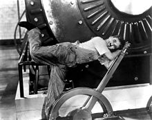 An example of physical comedy as Charlie Chaplin wrestles with factory controls in his 1936 comedy Modern Times Chaplin - Modern Times.jpg