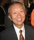 Portrait shot of a smiling
 man dressed in a suit.