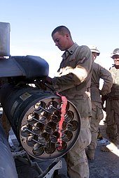 A rocket pod being loaded on an AH-1W's stub wing Cobra rocket.jpg