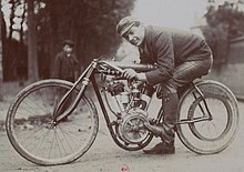 Photo de Giosuè Giuppone prenant la pose au guidon d'une moto Peugeot dans une position qui limite la prise au vent.