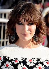 A snapshot photograph of Milla Jovovich, a brunette woman in her mid-thirties smiling and looking at the camera