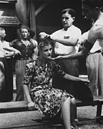 A woman's head is shaved as punishment for horizontal collaboration with Germans. Montelimar area, August 1944. This girl pays the penalty for having had personal relations with the Germans. Here, in the Montelimar area, France... - NARA - 531211.jpg