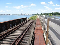 Abandoned rails still extant on a bridge adjacent to the bike path over Watchemoket Cove