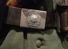 Nazi Germany Wehrmacht uniform belt buckle with traditional military slogan "Gott mit uns" ('God with us', 'With God on Our Side') and stylized Reichsadler eagle with swastika Nazi Germany Wehrmacht uniform belt buckle with traditional military slogan "Gott mit uns" ('God with us', 'With God on Our Side') and stylized Reichsadler eagle with swastika.jpg