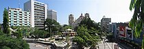 A view of a public square surrounded by buildings and decorated with trees