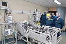 A critically ill patient receiving invasive ventilation in the intensive care unit of the Heart Institute, University of Sao Paulo in July 2020. Due to a shortage of mechanical ventilators, a bridge ventilator is being used to automatically actuate a bag valve mask. Respiradores da USP utilizados do Incor (50119127303).jpg