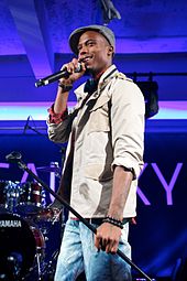 B.o.B performing with a michrophone.