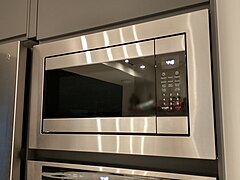 With the frame installed; the black cover piece immediately below (between microwave and oven) is a Nyttig filler piece