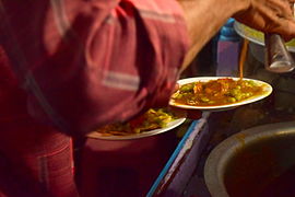 Masala puri being prepared by a street vendor