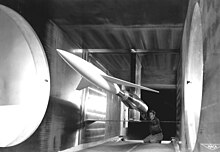 An engineer makes final calibrations to a model mounted in the 6-by-6-foot (1.8 m x 1.8 m) supersonic wind tunnel. Model in Supersonic Wind Tunnel GPN-2000-001631.jpg