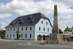 Stone guidepost and former inn