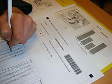 Some standardized testing uses multiple-choice tests, which are relatively inexpensive to score, but any form of assessment can be used. Cito Eindtoets Basisonderwijs.JPG