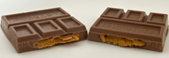 A Feastables Peanut Butter bar split in half to reveal peanut butter