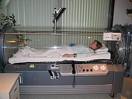 A person within a hyperbaric oxygen chamber HyperBaric Oxygen Therapy Chamber 2008.jpg