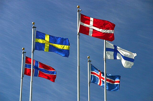 The flags of Denmark, Iceland, Finland, Sweden, and Norway flying on flagpoles