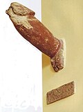 A phallus from a public alleyway in Pompeii that was 2 meteres up the side of a wall. The inscription reads "I shat out this one phallus/prick".[2] Tufa. Painted.