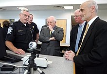 A U.S. Customs and Border Protection officer addresses Vice President Dick Cheney (center); Saxby Chambliss (center right), a U.S. Senator from Georgia; and Michael Chertoff (far right), the second head of the DHS; in 2005 US-border-patrol-20050502.jpg