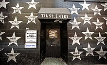 Door and awning of black building with silver stars