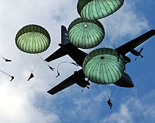 The Army 82nd Airborne Division performs a mass paratroop jump with during the 2006 Joint Service Open House hosted at Andrews Air Force Base, 20 May 2006. 82nd Airborne Mass Jump-JSOH2006.jpg