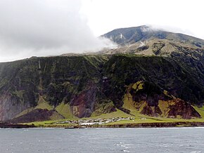 Edinburgh of the Seven Seas, the only settlement on Tristan da Cunha. Behind it is Queen Mary's Peak, a shield volcano. Edinburgh-Tristan.jpg