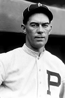 A man in a baseball uniform is shown from the chest up looking forward.