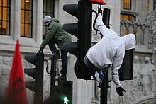 Protesters mount traffic lights in central London on 9 December 2010 Protestors in london climb traffic lights.jpg
