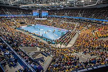 A handball game in progress at SAP Arena in Mannheim, Germany. Handball is one of the most popular team sports and historically evolved in Germany. SAP Arena Handball ausverkauft.jpg