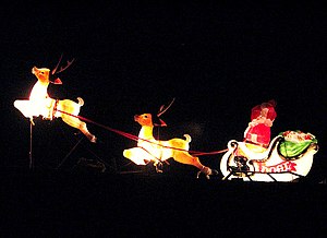 English: Santa and his reindeer flying past Ro...