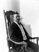 El Presidente Theodore Roosevelt sentado en una silla diseñada por White para el comedor de gala de la Casa Blanca, 1903.